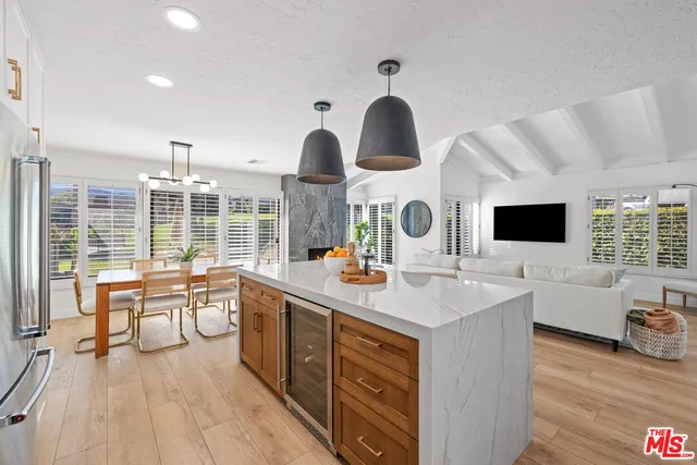 a kitchen with stainless steel appliances a sink and a large window