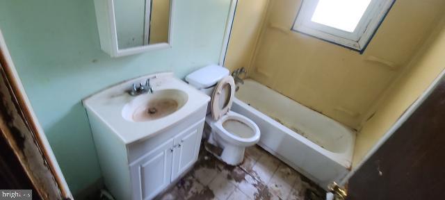 217 South Woodwell Road Dundalk, MD 21222 - Photo 39 of 49 a bathroom with a toilet sink and mirror