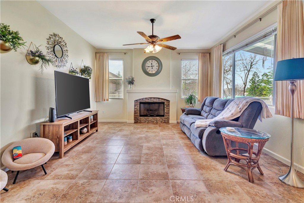 2104 Summit Drive Paso Robles, CA 93446 - Photo 14 of 31 a living room with furniture a fireplace and a flat screen tv