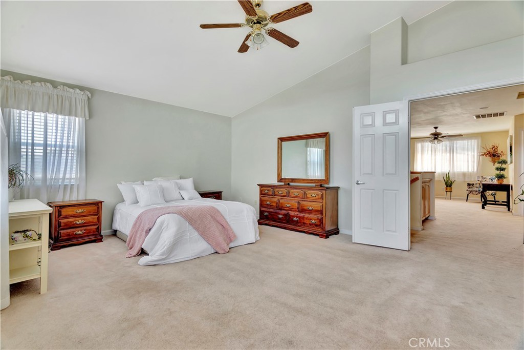2104 Summit Drive Paso Robles, CA 93446 - Photo 23 of 31 a spacious bedroom with a bed and a chandelier