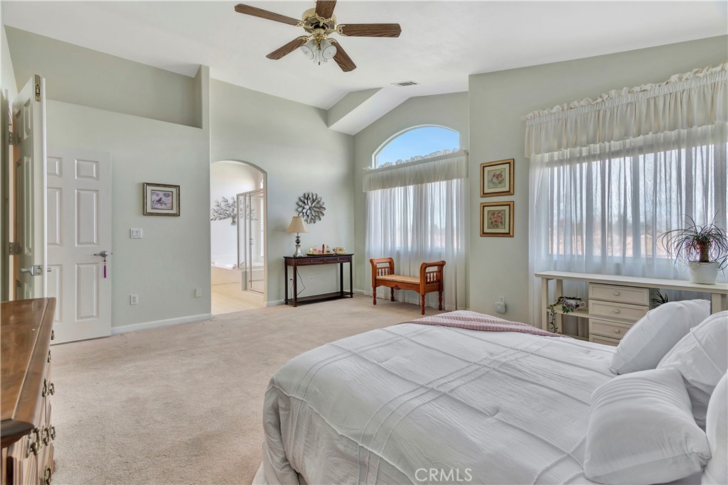 2104 Summit Drive Paso Robles, CA 93446 - Photo 24 of 31 a spacious bedroom with a bed and a chandelier