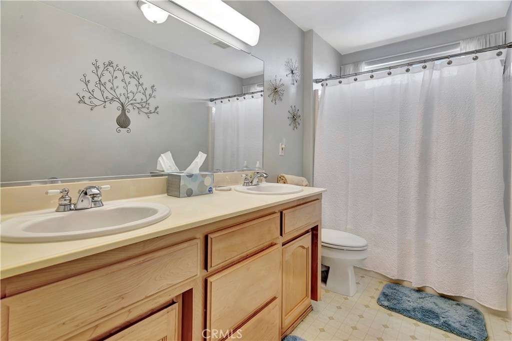 2104 Summit Drive Paso Robles, CA 93446 - Photo 29 of 31 a bathroom with a double vanity sink mirror and toilet