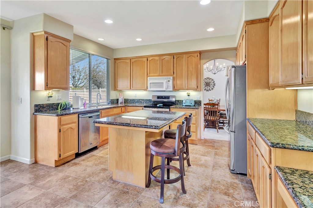 2104 Summit Drive Paso Robles, CA 93446 - Photo 10 of 31 a kitchen with stainless steel appliances kitchen island granite countertop a stove a sink and a refrigerator