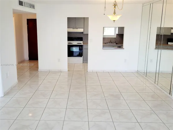 a view of a livingroom with a kitchen space and a window