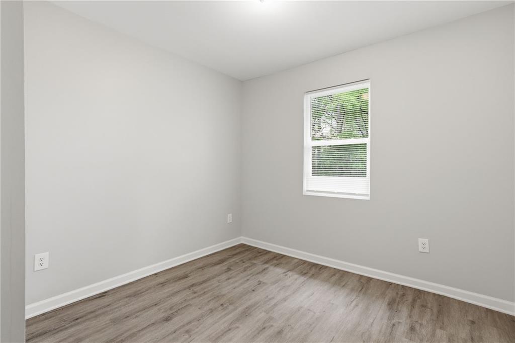 6981 Flagstone Drive Austell, GA 30168 - Photo 20 of 34 an empty room with wooden floor and windows
