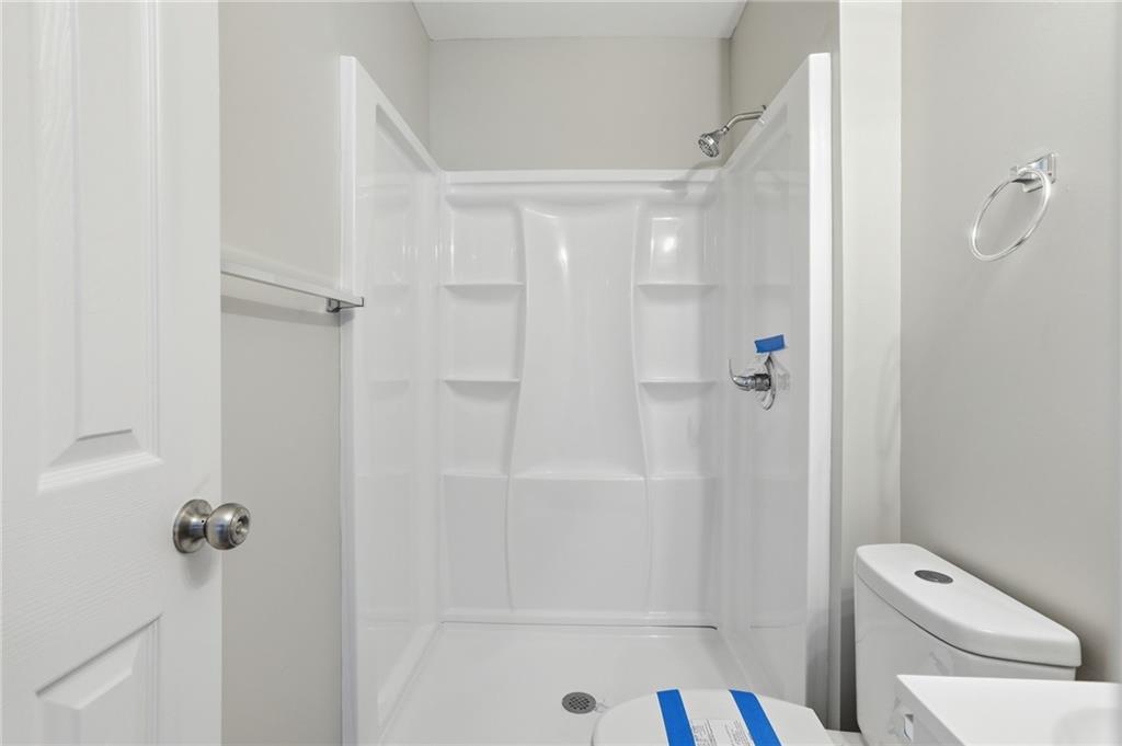 6981 Flagstone Drive Austell, GA 30168 - Photo 22 of 34 a bathroom with a sink a toilet and shower