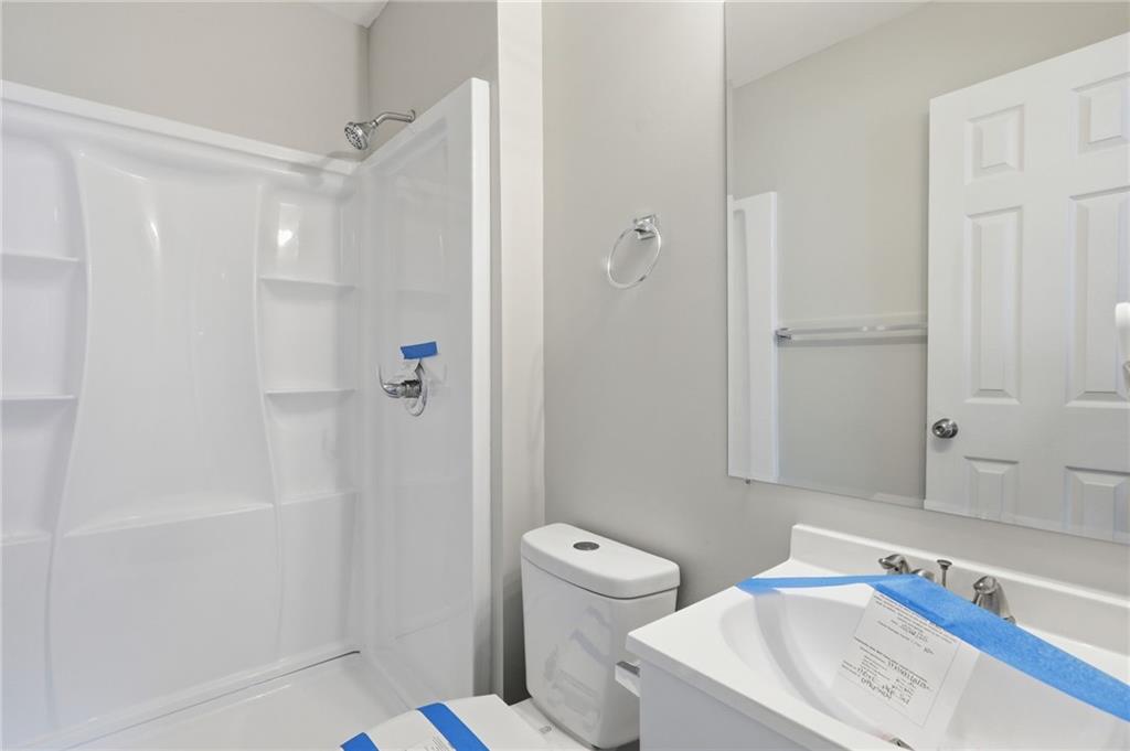 6981 Flagstone Drive Austell, GA 30168 - Photo 23 of 34 a bathroom with a sink a toilet and shower