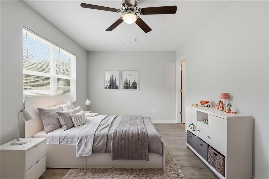 6981 Flagstone Drive Austell, GA 30168 - Photo 3 of 34 a bedroom with a bed and a chandelier
