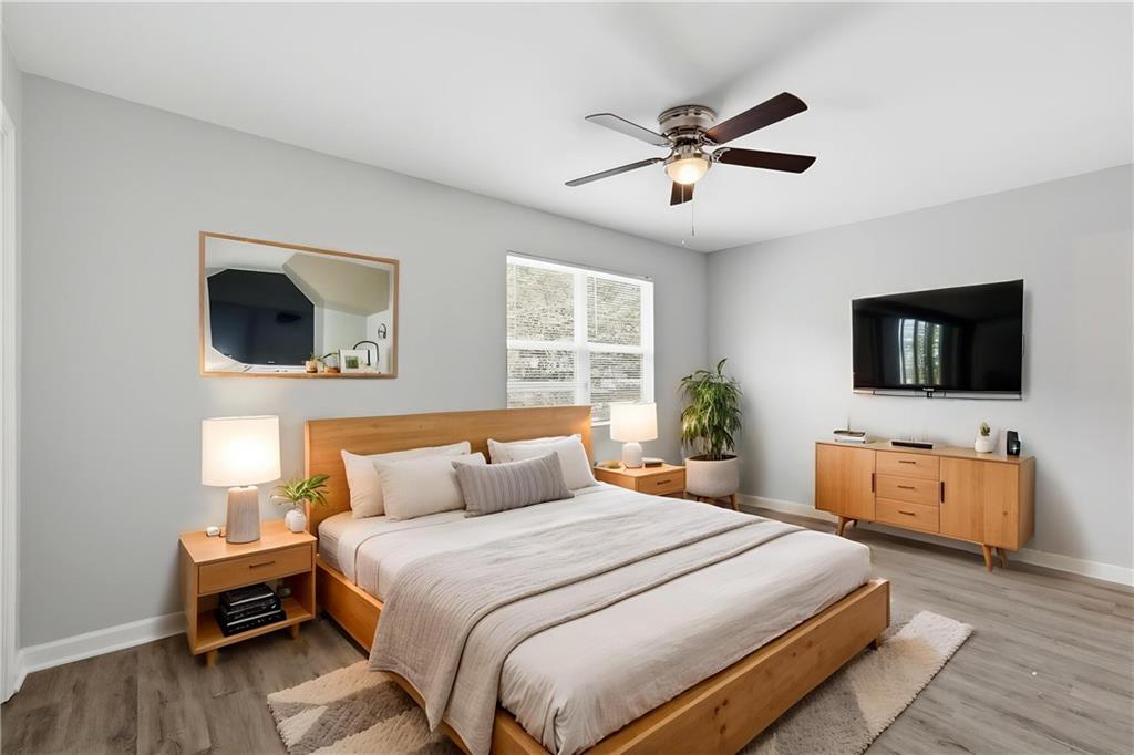 6981 Flagstone Drive Austell, GA 30168 - Photo 5 of 34 a bedroom with a bed and a flat screen tv