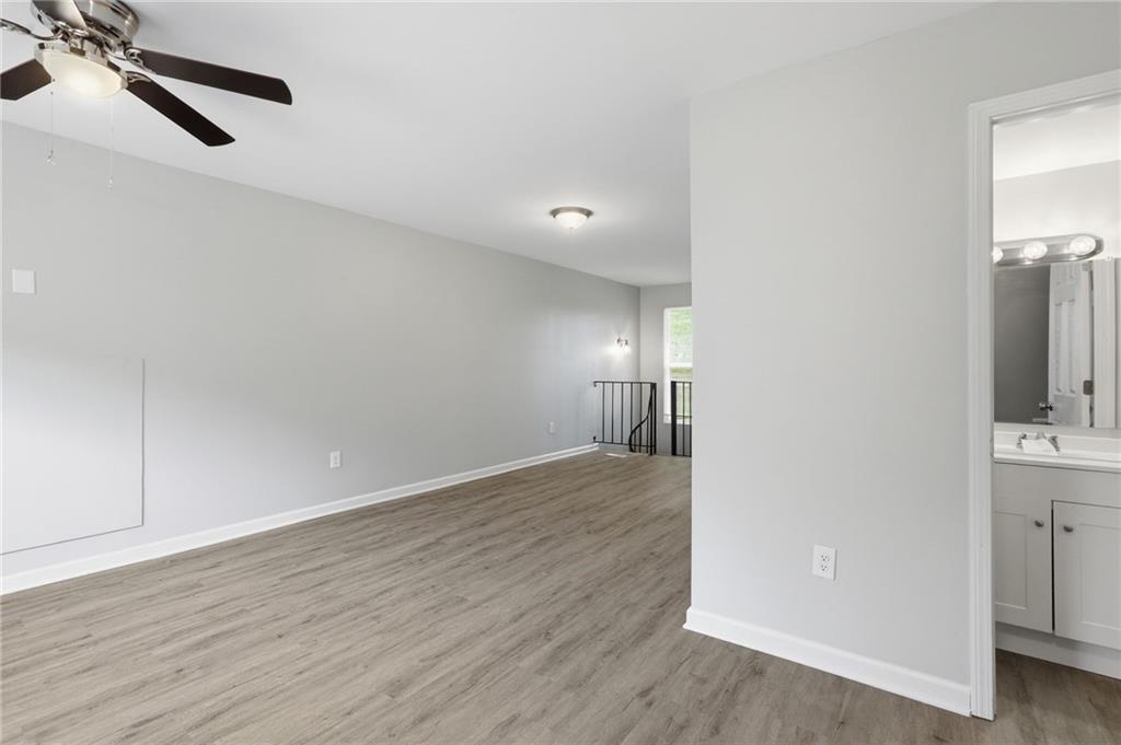 6981 Flagstone Drive Austell, GA 30168 - Photo 6 of 34 an empty room with wooden floor cabinet and windows