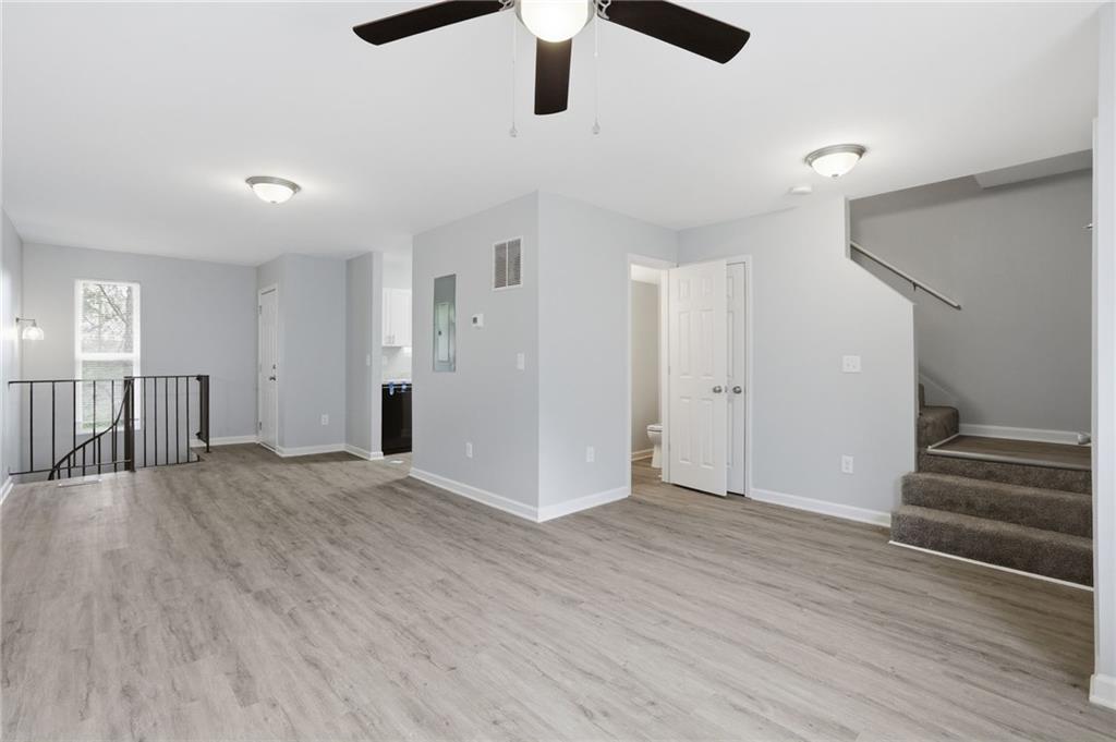6981 Flagstone Drive Austell, GA 30168 - Photo 7 of 34 an empty room with wooden floor and windows
