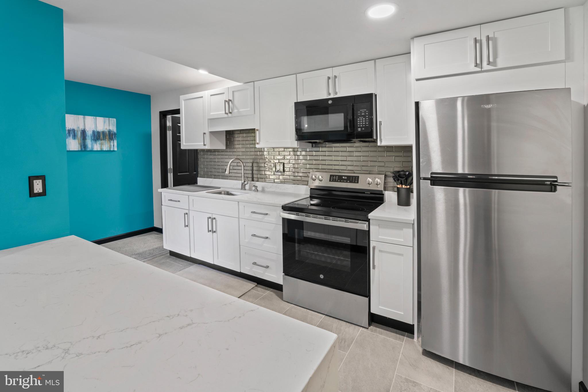 23 Regal's Court Swedesboro, NJ 08085 - Photo 69 of 74 a kitchen with stainless steel appliances a refrigerator stove and microwave