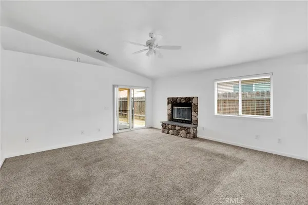 an empty room with furniture and windows