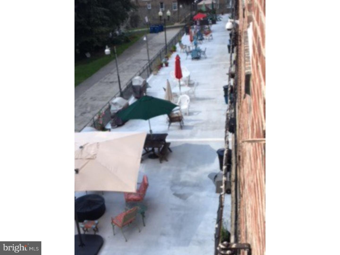 6138 Wayne Avenue, Unit 2 Philadelphia, PA 19144 - Photo 10 of 11 a view of water heater and room with wooden floor