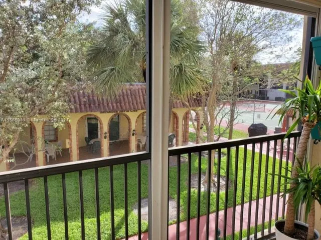 a view of a balcony with tree