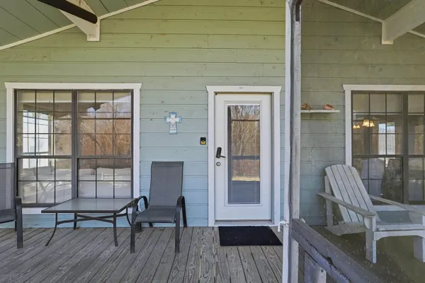 a view of a balcony with chairs and with wooden floor