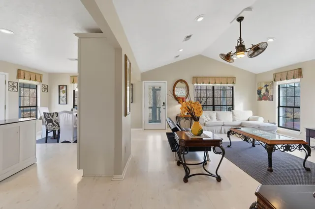 a living room with furniture a rug and a chandelier