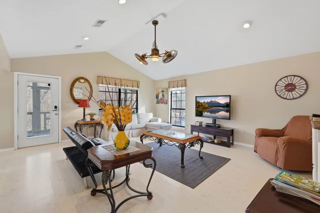 a living room with furniture a rug and a chandelier