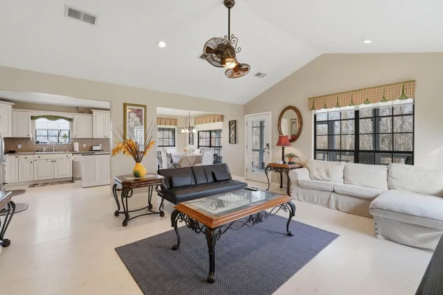 a living room with furniture a rug and a chandelier