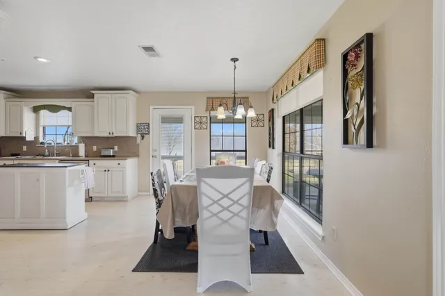 a living room with granite countertop furniture and a chandelier