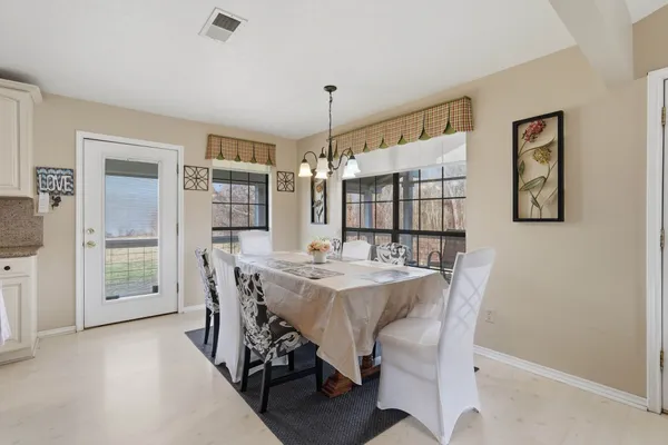 a view of a dining room with furniture and window