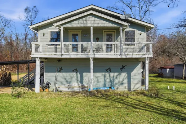a front view of a house with a yard table and chairs