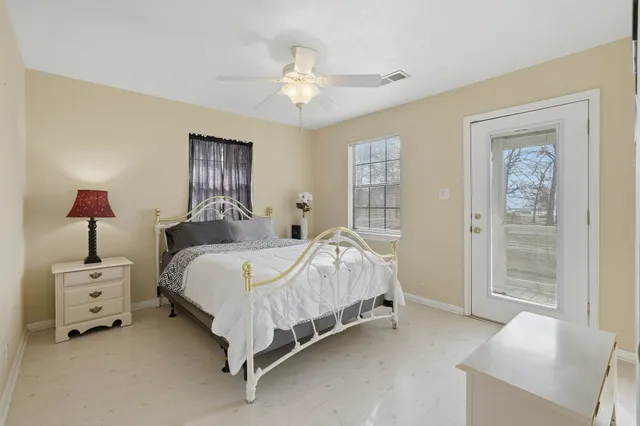 a bed room with a bed and a ceiling fan