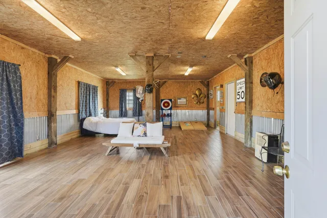 a spacious bedroom with a bed a table and painting on the wall