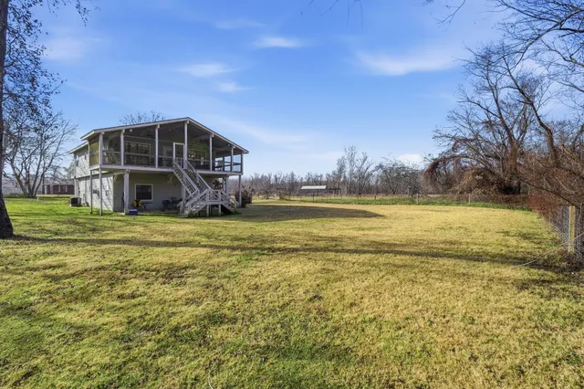 a view of a dry yard with wooden fence