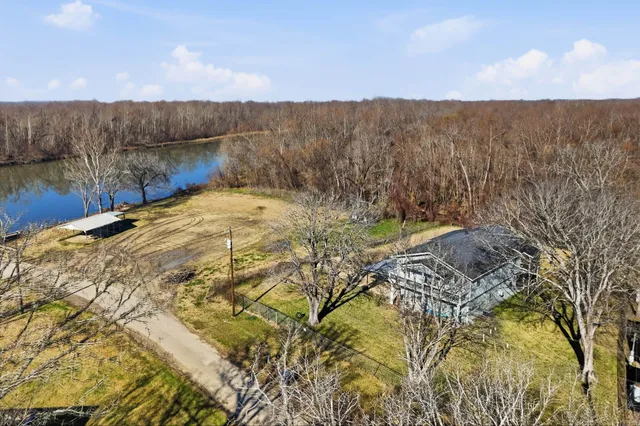 an aerial view of a house with a swimming pool outdoor seating and yard