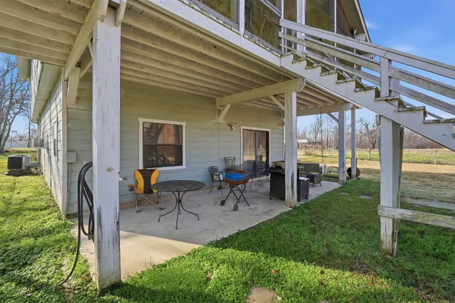 a view of a patio with table and chairs and potted plants