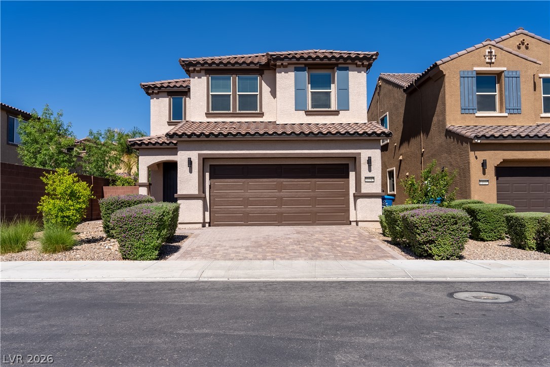 11045 Elk Sands Road Las Vegas, NV 89179 - Photo 43 of 67 Spanish tile roofing and a paved driveway enhance this contemporary two-story home.
