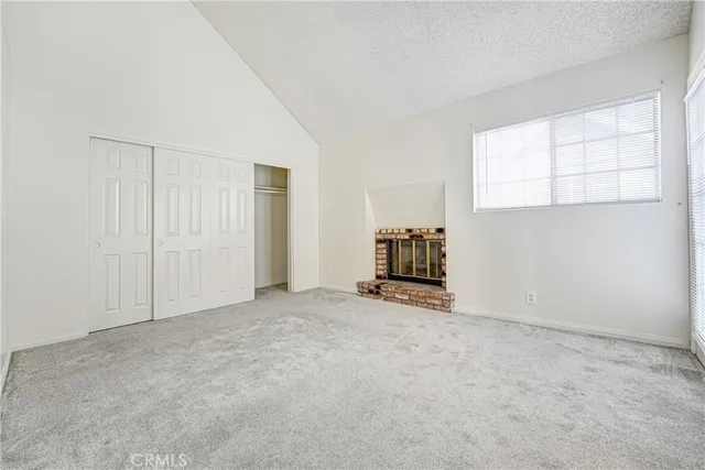 an empty room with furniture and windows