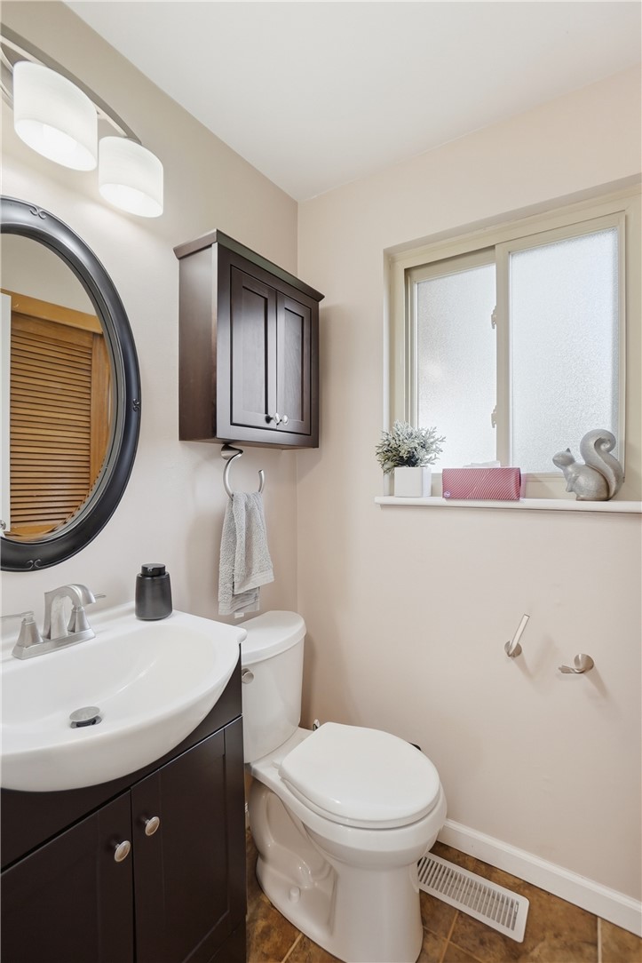150 Littlejohn Road Troy, OH 45373 - Photo 18 of 40 This bathroom features a contemporary vanity and toilet, complete with a practical storage cabinet.