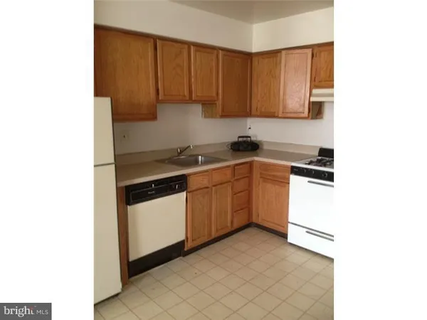 a kitchen with a sink cabinets and a window