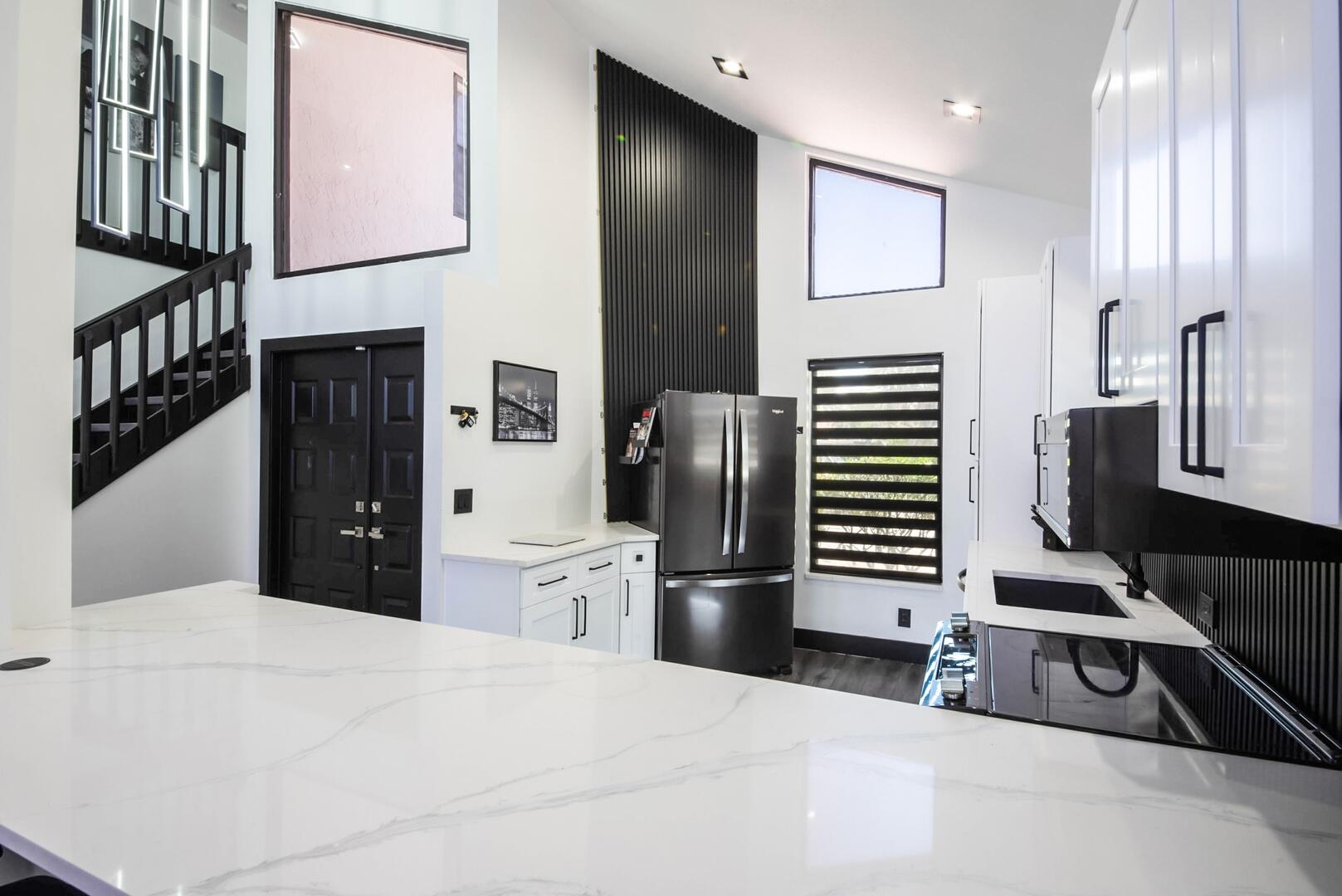 8658 Kimble Way Boca Raton, FL 33433 - Photo 11 of 33 a kitchen with stainless steel appliances kitchen island granite countertop a refrigerator and a stove top oven