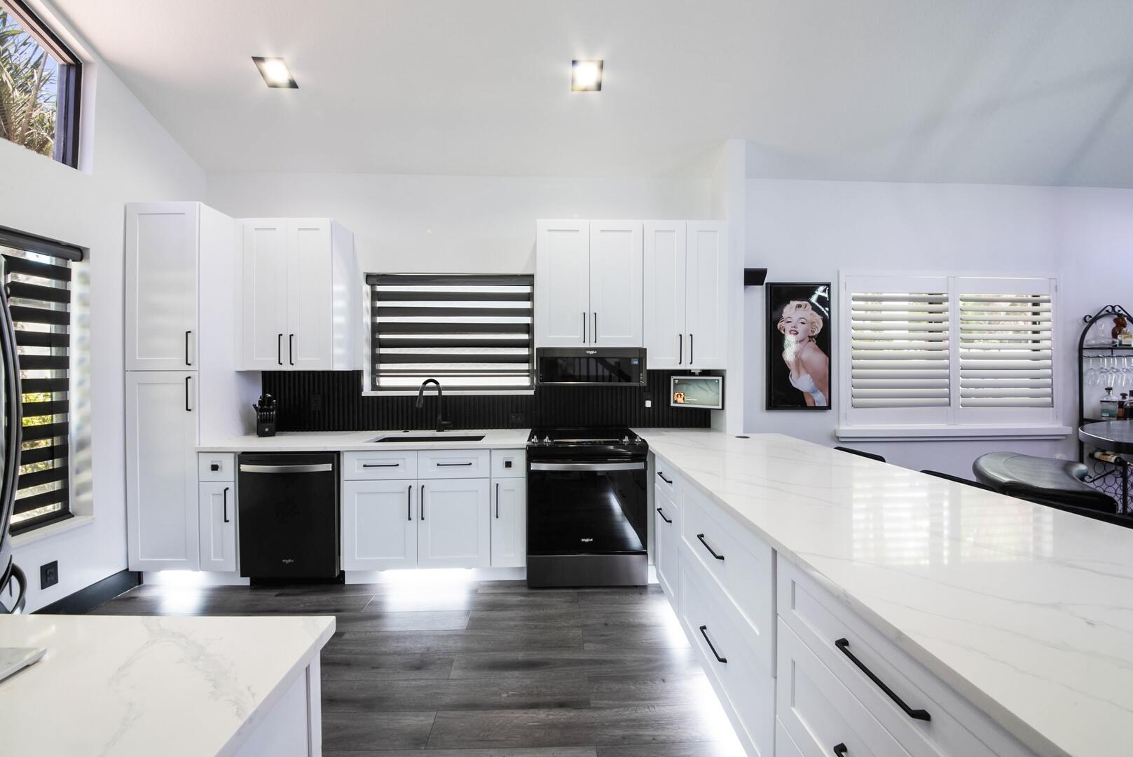 8658 Kimble Way Boca Raton, FL 33433 - Photo 13 of 33 a large kitchen with a stove top oven a sink a dining table and chairs