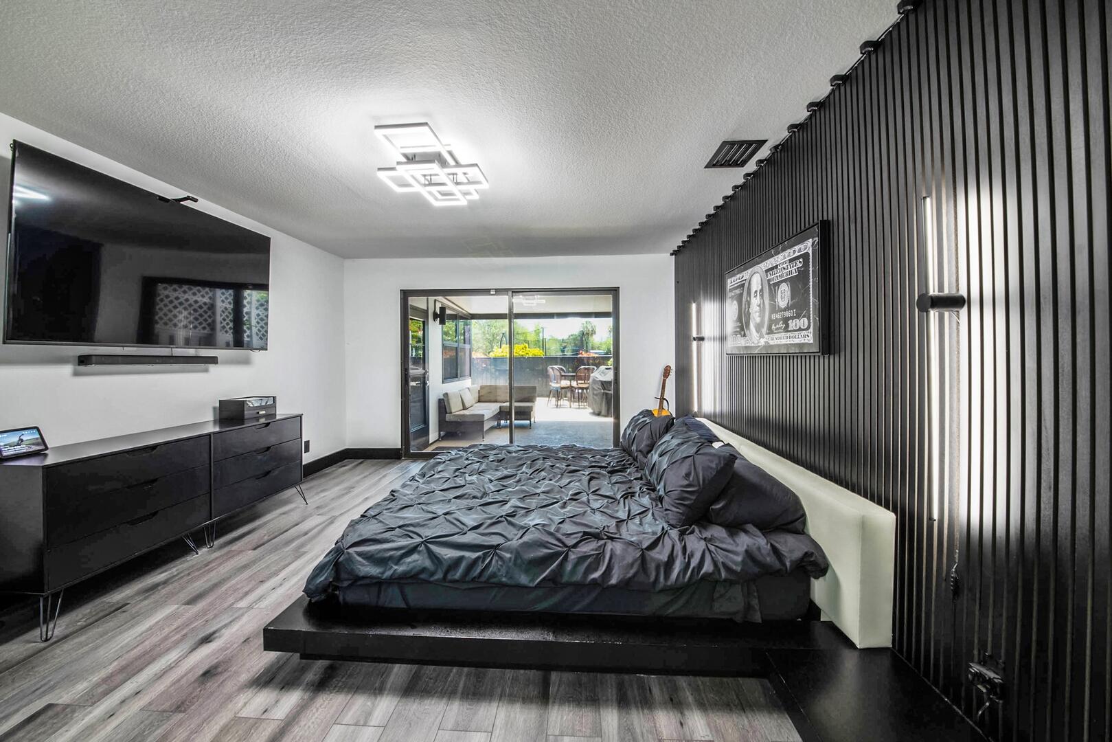 8658 Kimble Way Boca Raton, FL 33433 - Photo 15 of 33 a bedroom with a large bed and a flat tv screen on dresser