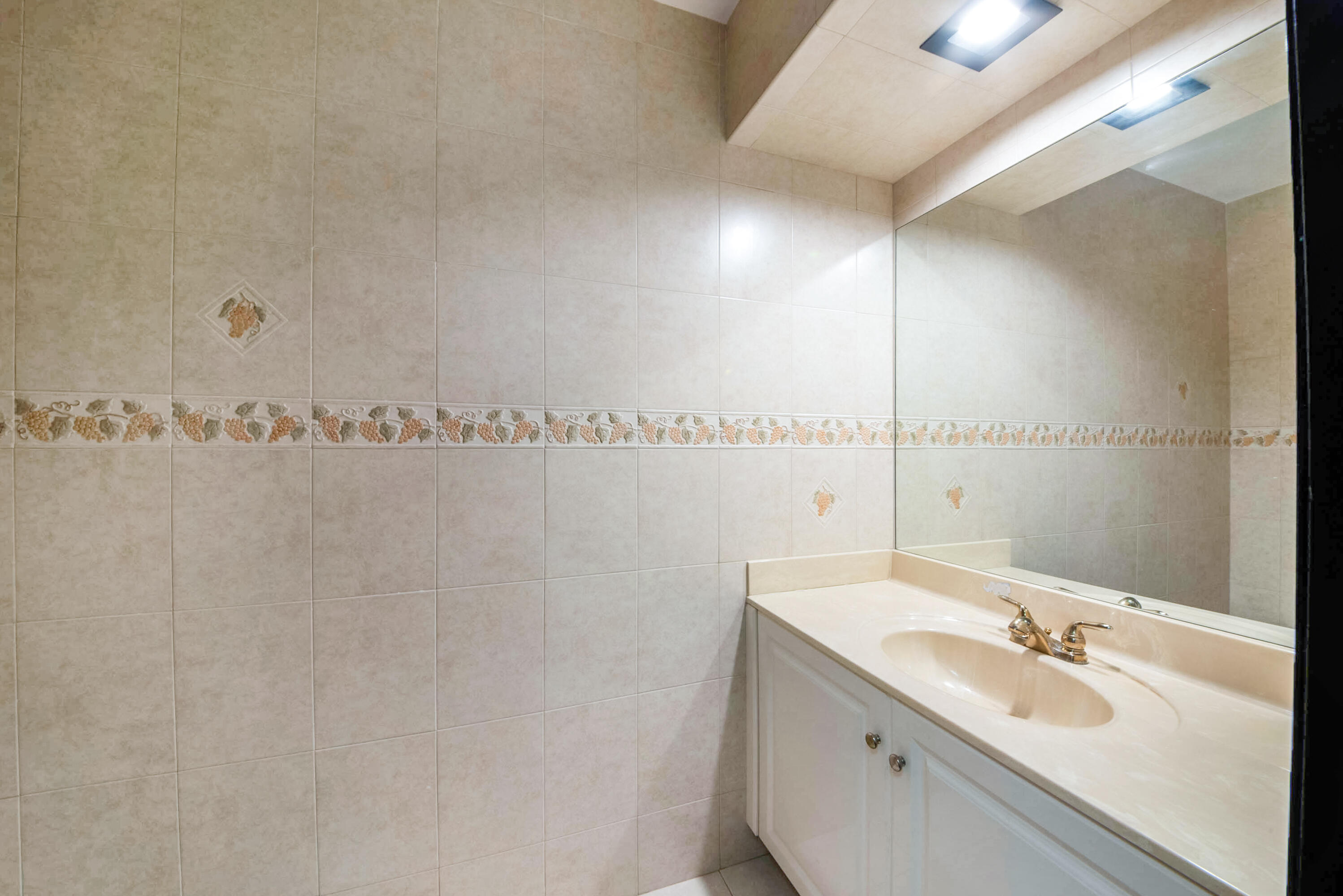 8658 Kimble Way Boca Raton, FL 33433 - Photo 18 of 33 a bathroom with a sink and a mirror