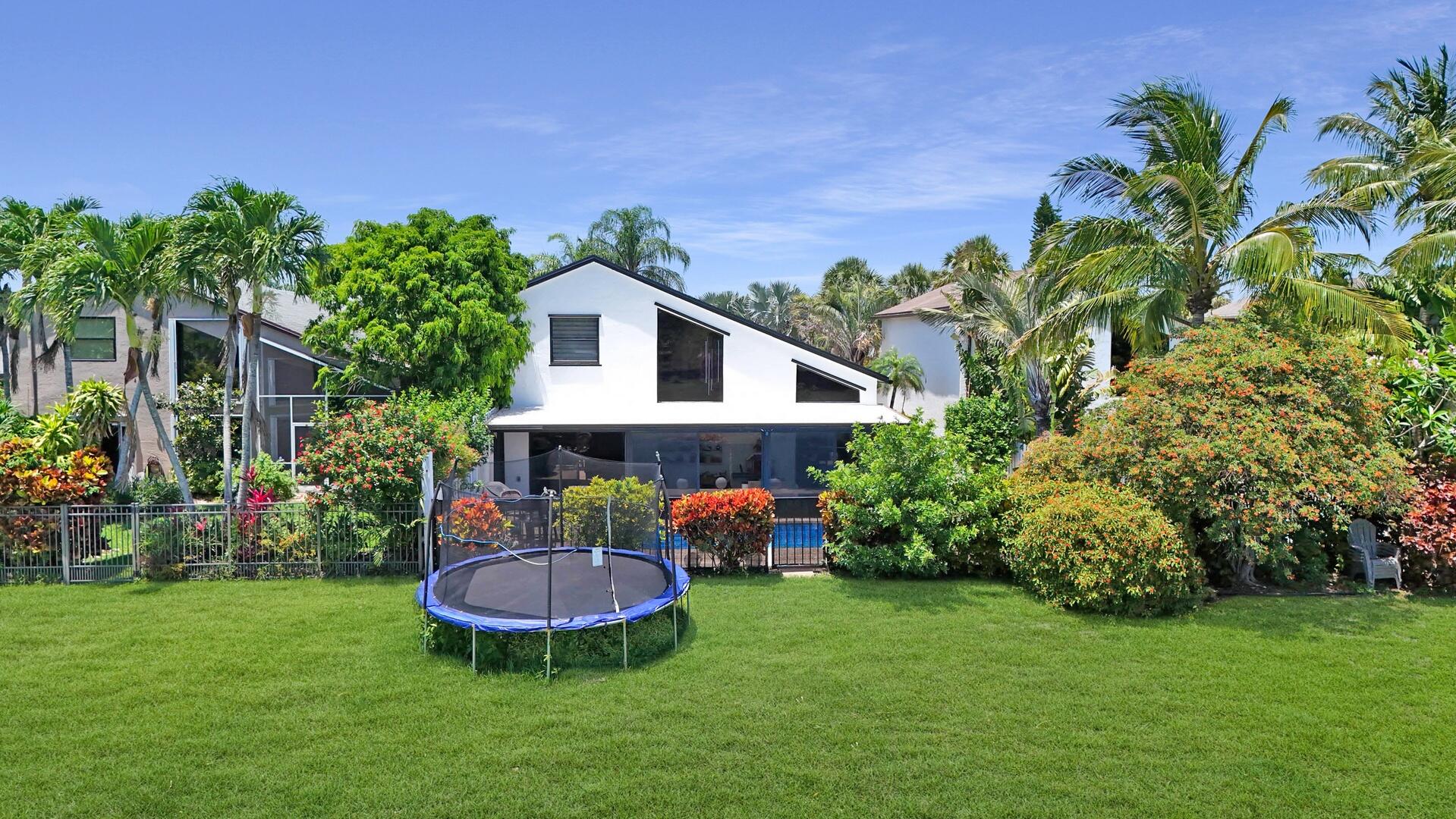 8658 Kimble Way Boca Raton, FL 33433 - Photo 26 of 33 a view of a backyard with plants and a garden
