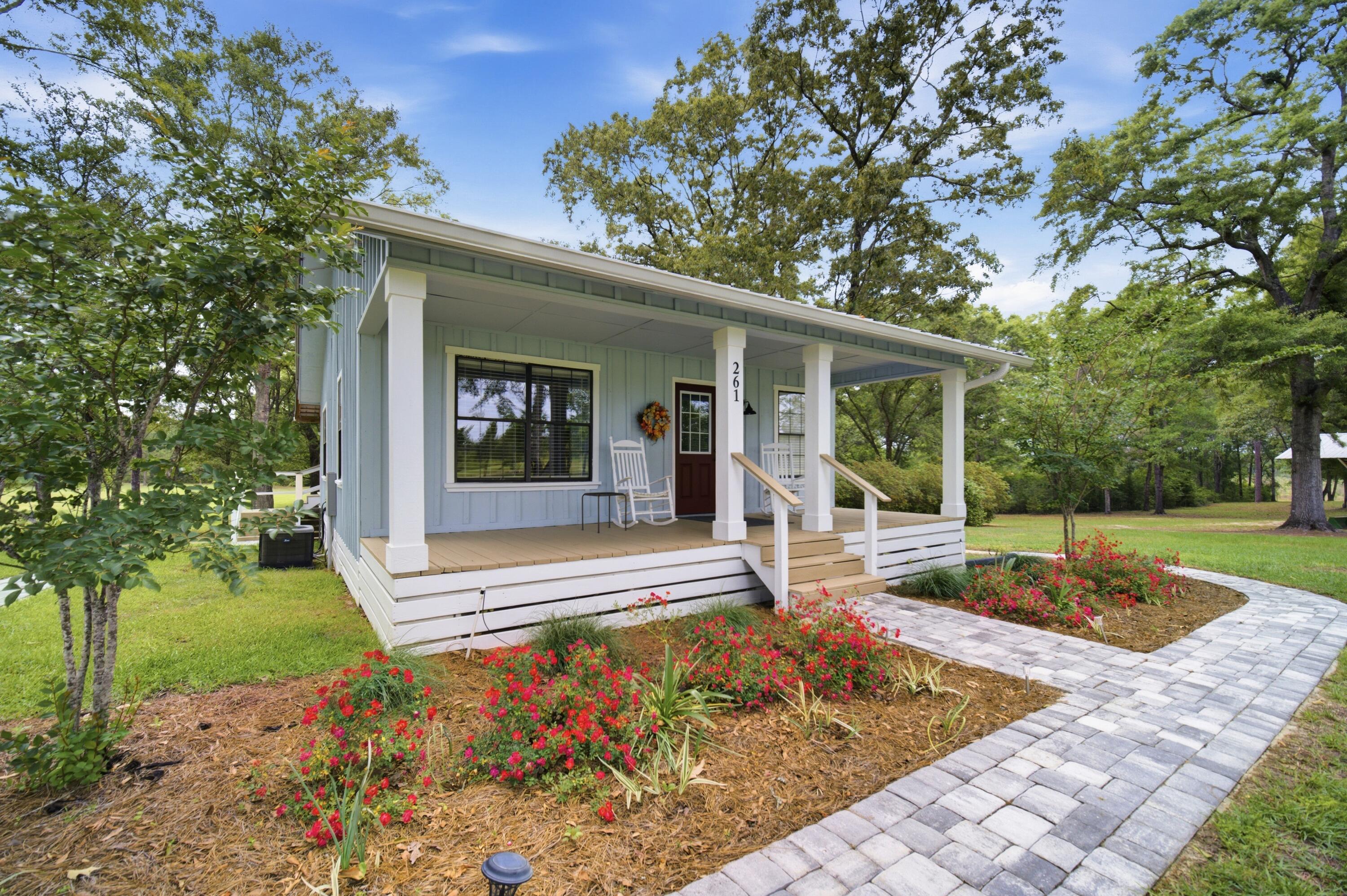 261 Wilkerson Road DeFuniak Springs, FL 32433 - Photo 39 of 76 a view of a house with backyard porch and sitting area