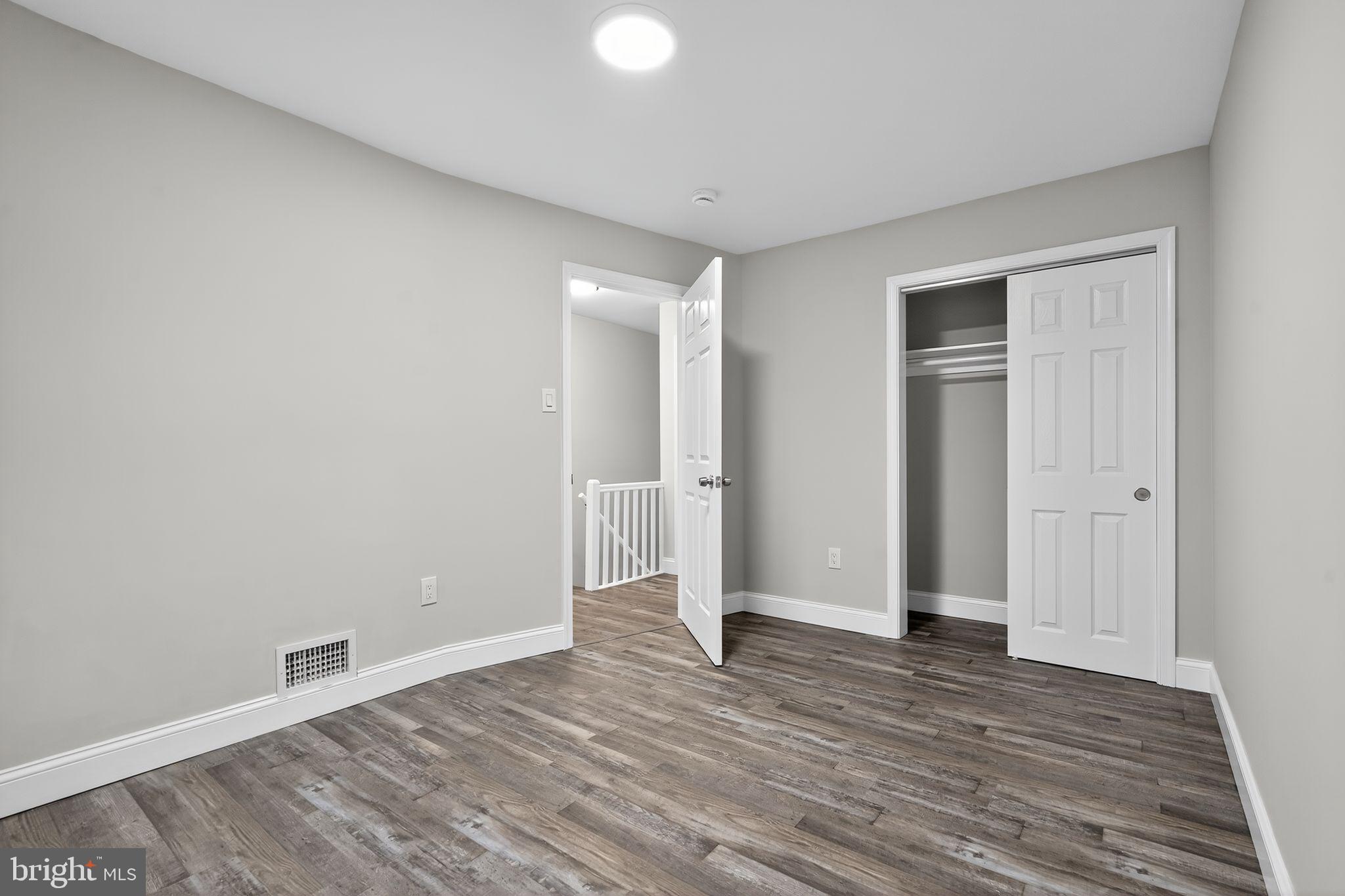 5706 Mitchell Road Levittown, PA 19057 - Photo 12 of 19 a view of an empty room with wooden floor