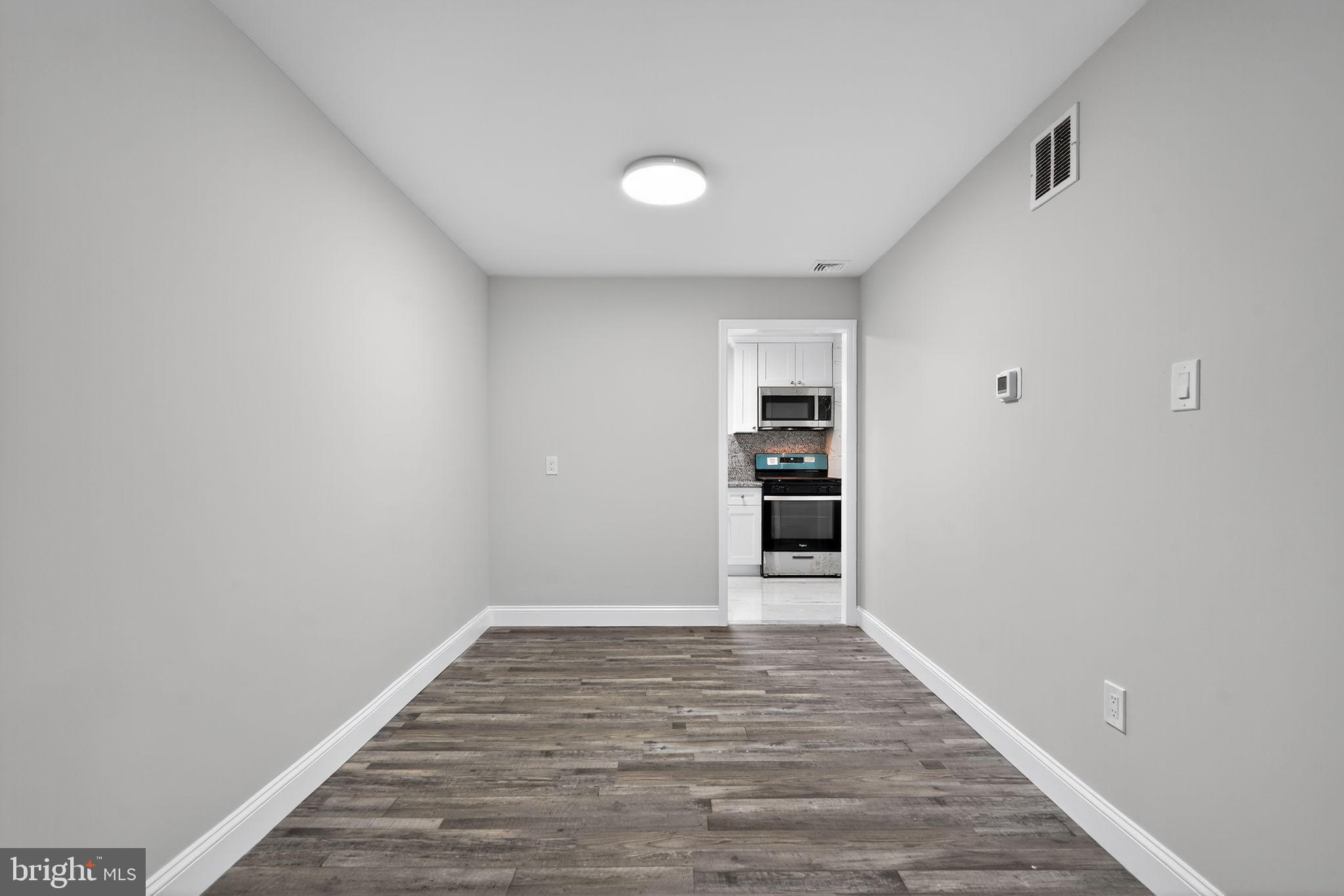 5706 Mitchell Road Levittown, PA 19057 - Photo 13 of 19 a view of empty room with wooden floor