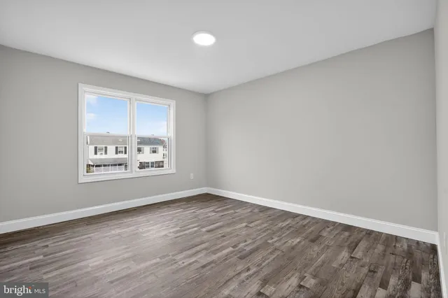 a view of a room with window and hardwood floor