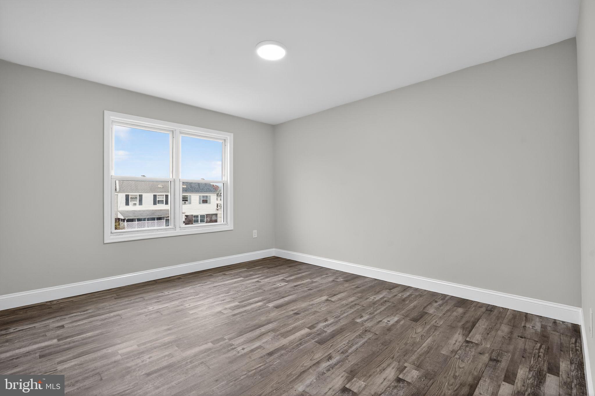 5706 Mitchell Road Levittown, PA 19057 - Photo 14 of 19 a view of a room with window and hardwood floor
