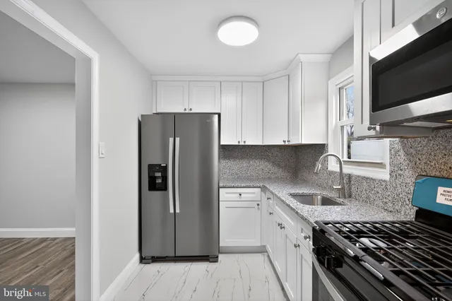 a kitchen with a refrigerator and a sink