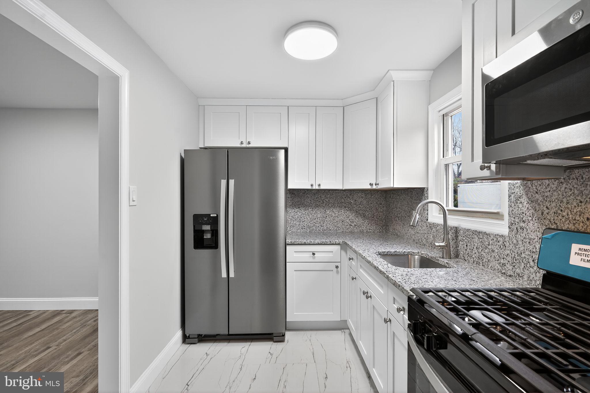 5706 Mitchell Road Levittown, PA 19057 - Photo 3 of 19 a kitchen with a refrigerator and a sink