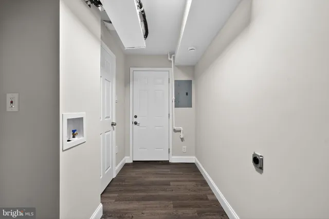 a view of a hallway with wooden floor and entryway