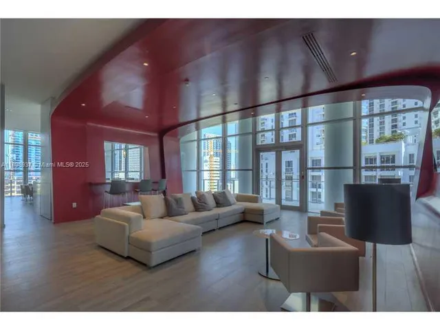 a living room with furniture and a large window