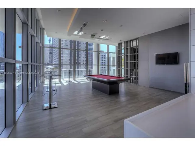 a living room with furniture window and flat screen tv